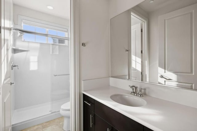 bathroom with tile patterned flooring, vanity, toilet, and a shower with door