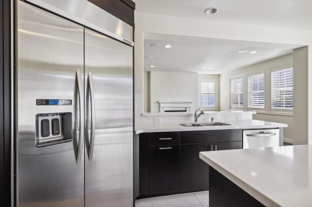 kitchen featuring sink, light tile patterned floors, and appliances with stainless steel finishes