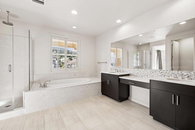 bathroom featuring tile patterned flooring, vanity, independent shower and bath, and tasteful backsplash