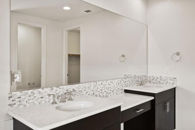 bathroom featuring decorative backsplash and vanity