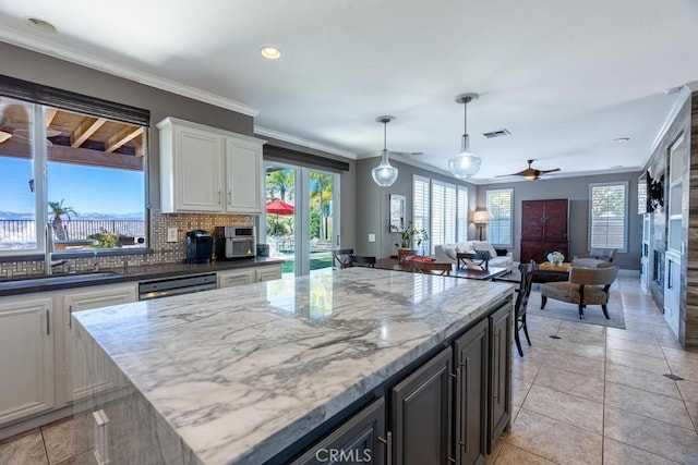 kitchen featuring ceiling fan, sink, tasteful backsplash, crown molding, and white cabinets