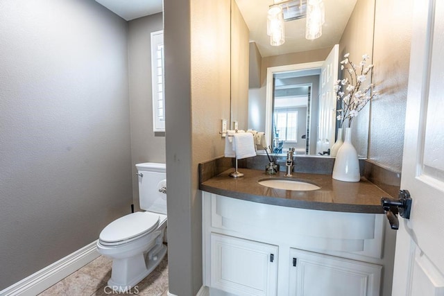 bathroom featuring tile patterned floors, vanity, and toilet