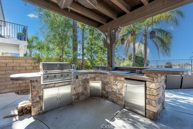 view of patio / terrace with ceiling fan and area for grilling