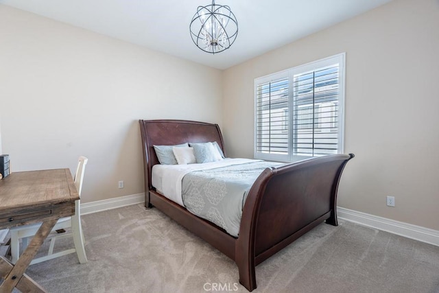 bedroom featuring a notable chandelier and light colored carpet