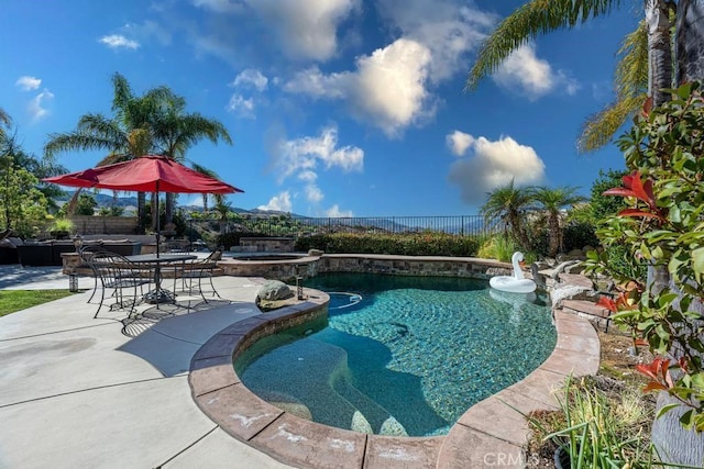 view of pool featuring an in ground hot tub and a patio