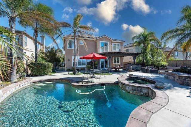 view of swimming pool with an in ground hot tub and a patio