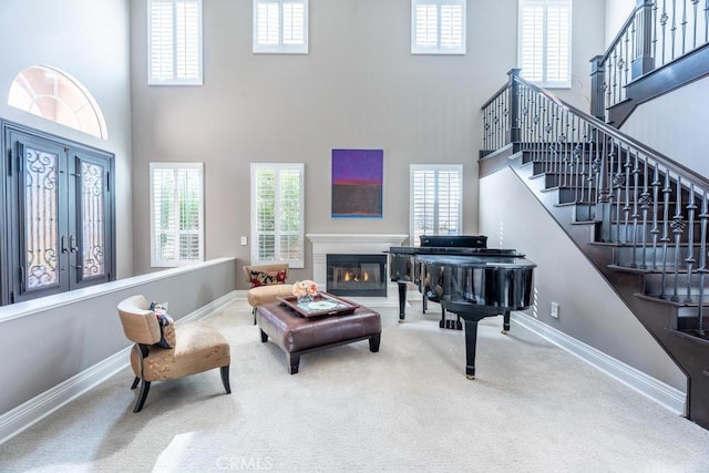 living room featuring carpet flooring and a high ceiling