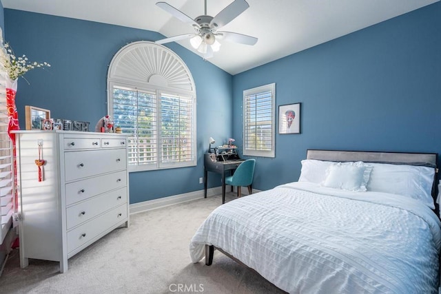 carpeted bedroom with ceiling fan and vaulted ceiling