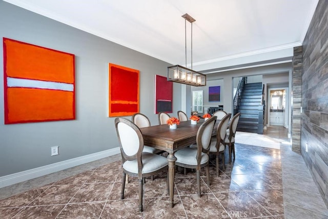 dining space featuring crown molding and tile walls