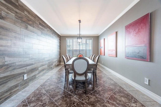 dining area featuring ornamental molding and an inviting chandelier