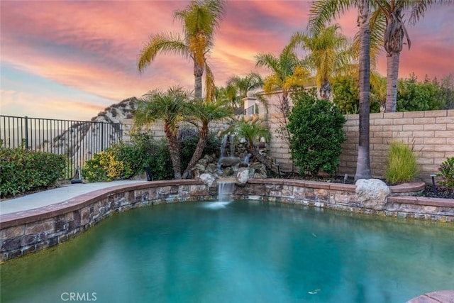 view of pool featuring fence