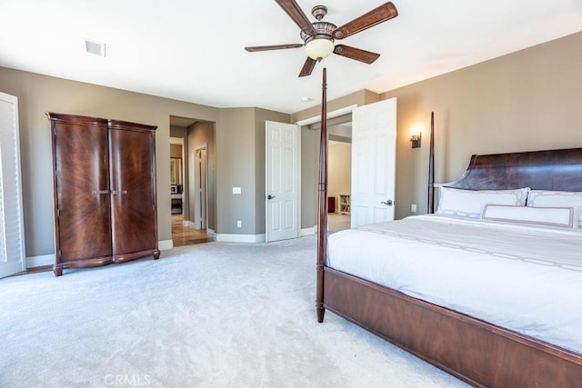 bedroom featuring baseboards, visible vents, ceiling fan, and light colored carpet