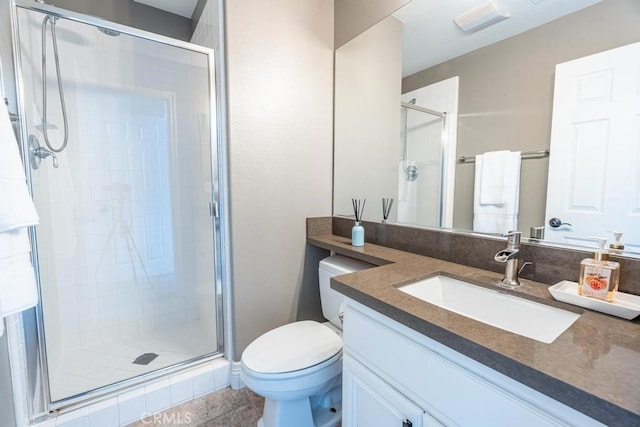 bathroom featuring a stall shower, vanity, and toilet