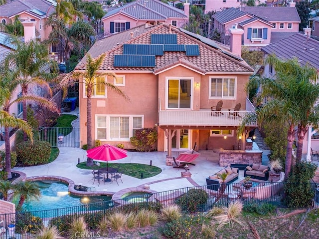 back of house with a patio, a fenced backyard, a tile roof, an outdoor living space, and stucco siding