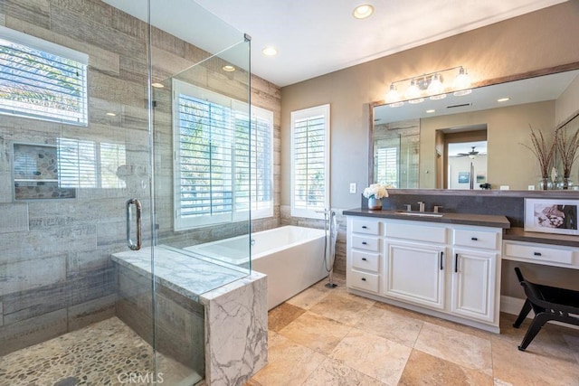 full bathroom featuring a stall shower, a soaking tub, vanity, and recessed lighting