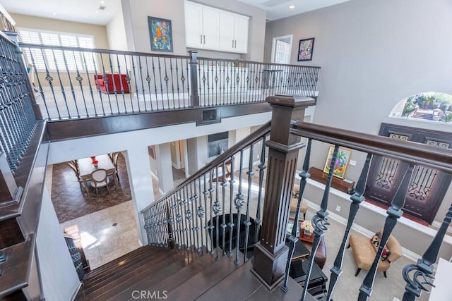 stairway with baseboards and visible vents