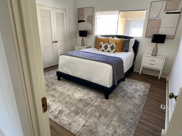 bedroom featuring dark hardwood / wood-style floors and a closet