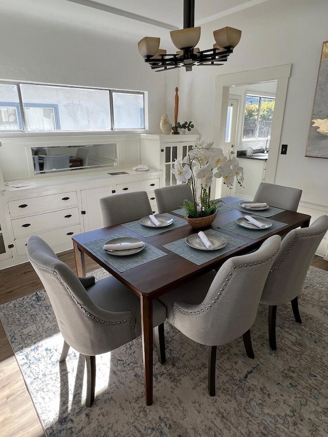 dining area with a chandelier and light hardwood / wood-style flooring