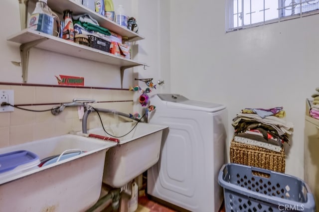 laundry area featuring separate washer and dryer and sink