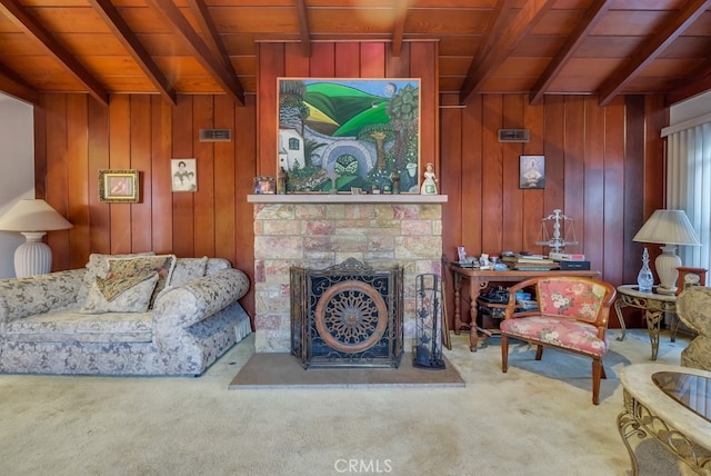 living room featuring wood ceiling, beam ceiling, wood walls, and a stone fireplace