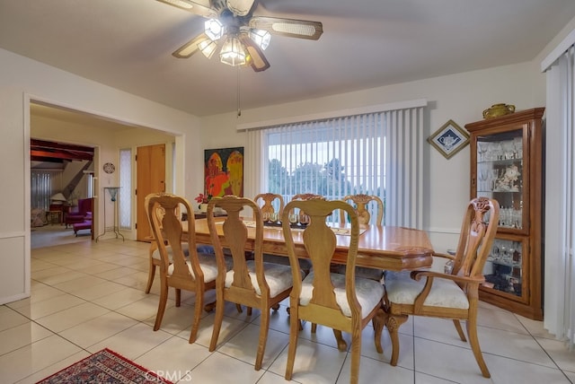 tiled dining area featuring ceiling fan