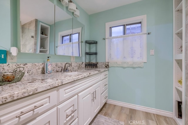 bathroom with vanity and hardwood / wood-style flooring