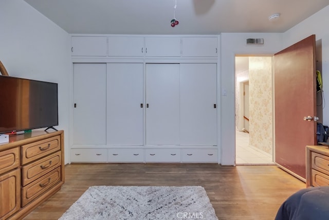 bedroom featuring a closet and light hardwood / wood-style floors