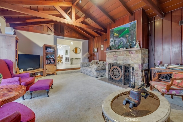 carpeted living room with wooden walls, wooden ceiling, ceiling fan, high vaulted ceiling, and beamed ceiling