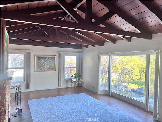 interior space featuring wooden ceiling, wood-type flooring, access to exterior, and lofted ceiling with beams