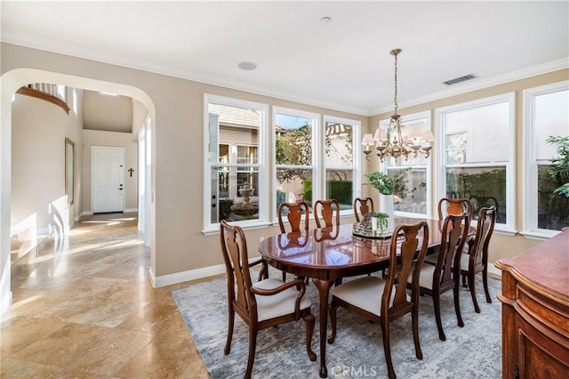 dining space with a chandelier and ornamental molding