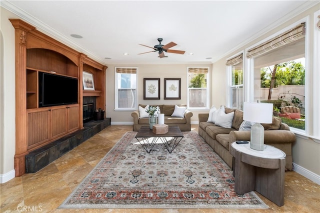 living room with ceiling fan and ornamental molding