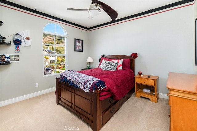 bedroom with ceiling fan, crown molding, and light carpet