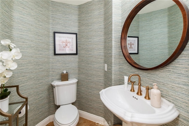 bathroom featuring toilet and sink