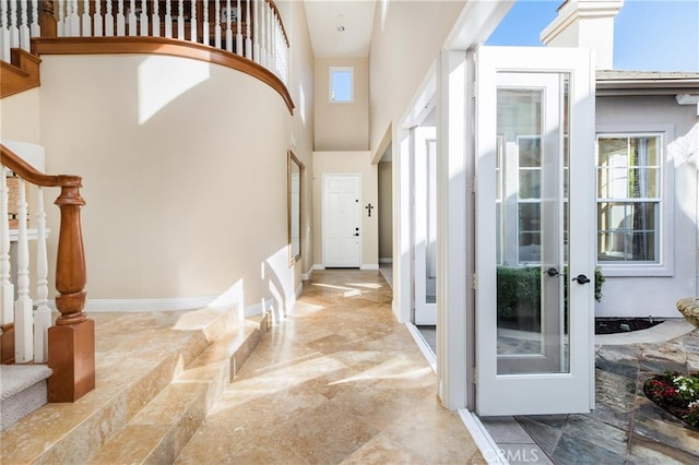 foyer entrance with a high ceiling and french doors