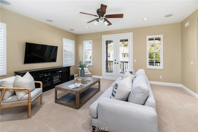 carpeted living room featuring ceiling fan and french doors