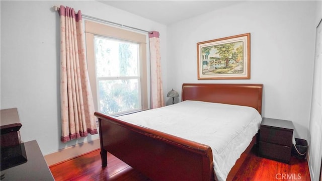 bedroom featuring dark hardwood / wood-style flooring