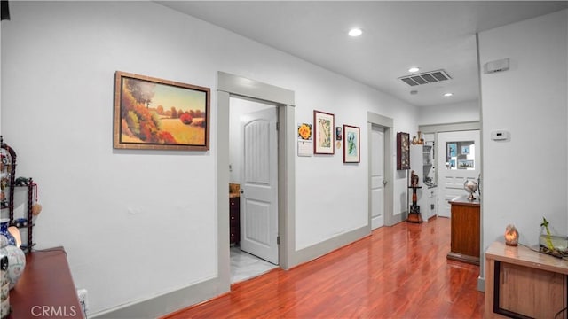 corridor with light wood-type flooring