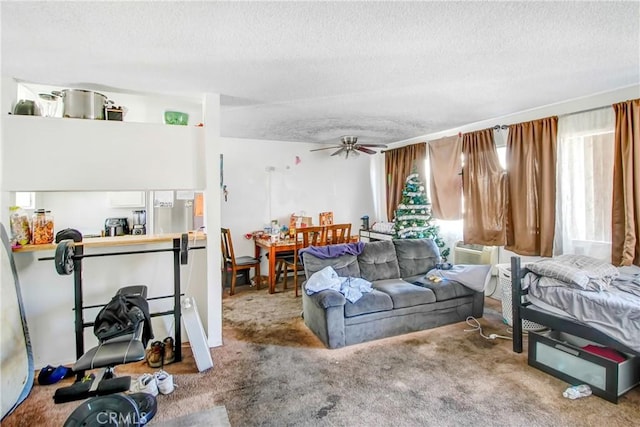 bedroom featuring carpet flooring, a textured ceiling, and ceiling fan