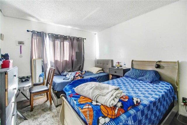 carpeted bedroom featuring a textured ceiling