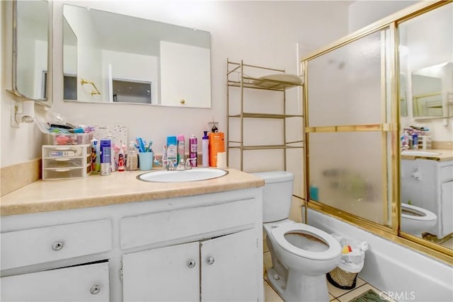 full bathroom featuring tile patterned floors, vanity, bath / shower combo with glass door, and toilet