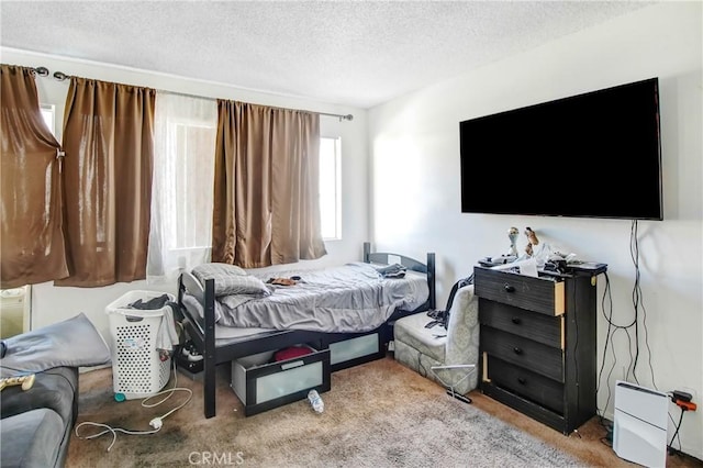 carpeted bedroom featuring a textured ceiling