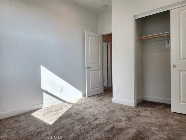 unfurnished bedroom featuring carpet floors and a closet