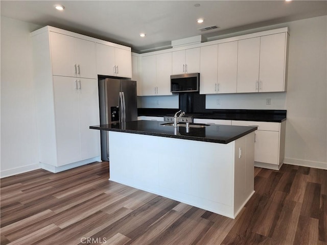 kitchen featuring a center island with sink, white cabinets, stainless steel appliances, and sink