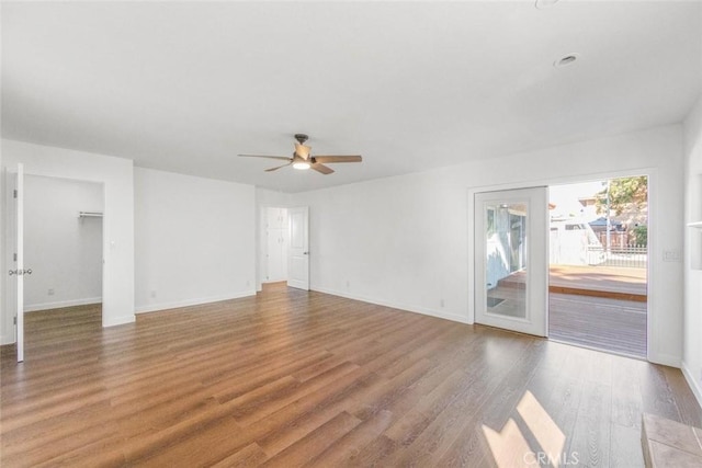 unfurnished room with ceiling fan and hardwood / wood-style flooring