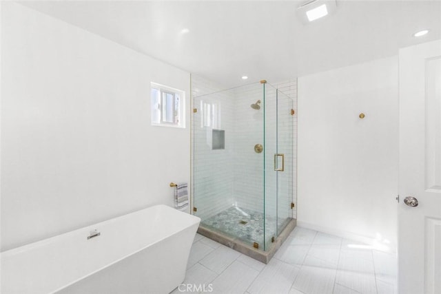 bathroom featuring tile patterned flooring and separate shower and tub