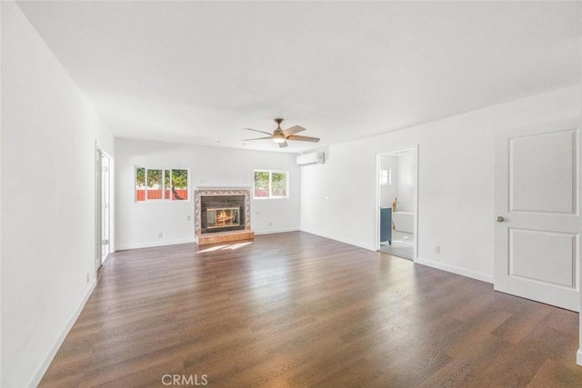 unfurnished living room with dark hardwood / wood-style floors, ceiling fan, and a wall unit AC