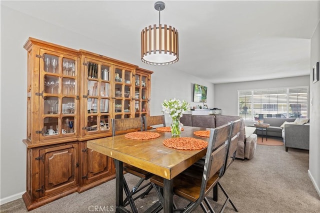 dining area featuring light colored carpet