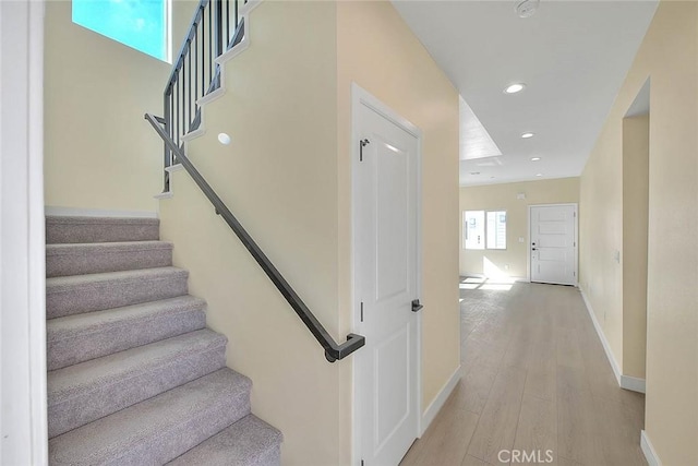 stairway with hardwood / wood-style floors