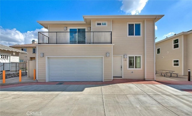 view of front of property featuring a balcony and a garage