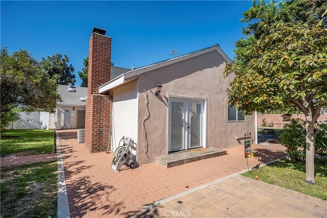 rear view of property with cooling unit